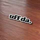 Uff Da Sticker on Wood Desk in Office