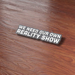 We Need Our Own Reality Show Funny Sticker on Wood Desk in Office