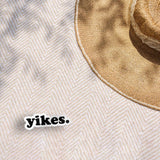 Yikes Typography Sticker outdoors on beach towel