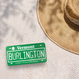 Burlington Vermont License Plate Bumper Sticker Outdoors on Beach Blanket