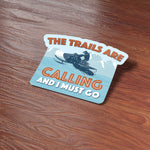 The Trails are Calling Snowmobile Sticker on Wood Desk